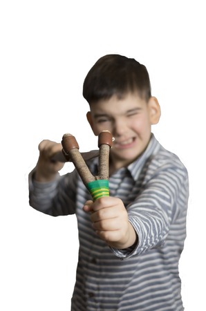 boy with a slingshot in his hands
