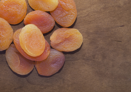 Colored dried apricots on wooden table, closeupの写真素材