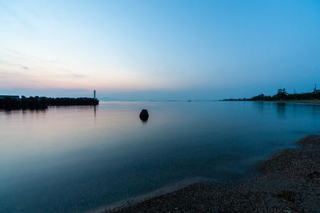 Smooth lake surface of Lake Biwa in the early morningの写真素材