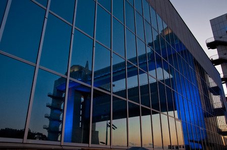 Illuminations reflected on the glass windows of the Numazu harbor structureの写真素材