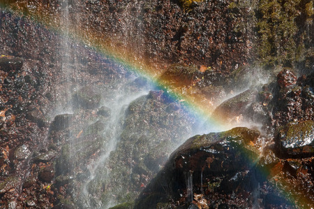 Waterfall splash and rainbow clearlyの写真素材