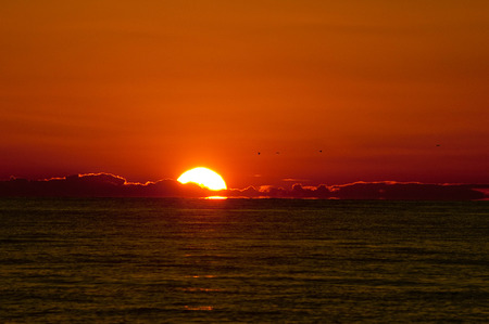 A half-sunset on the horizonの写真素材