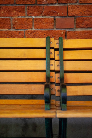 Brown bench made of brick wall and woodの写真素材