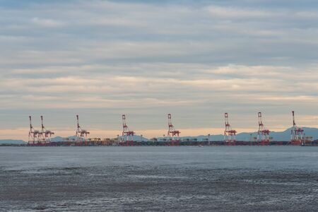 A huge crane of Osaka Port lined with manyの写真素材