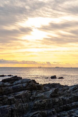 Sea, reefs and sunrise sky in Wakayamaの写真素材