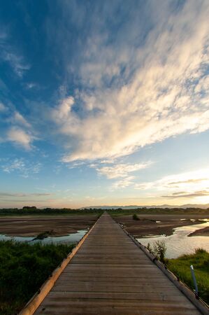 The wooden bridge over the river in Kyoto and the skyの写真素材
