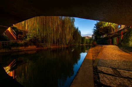 Dawn as seen from under a bridge on a canal in Kyotoの写真素材
