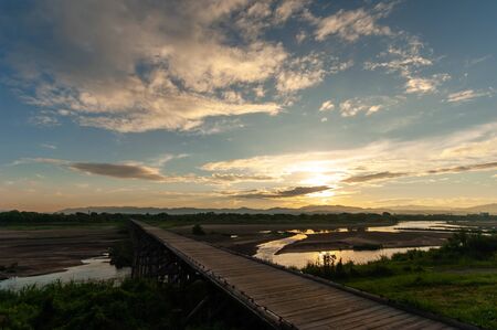 Wooden bridge over the river in Kyoto and the morning sunの写真素材