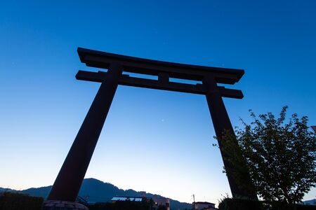 Huge torii and blue sky at dawnの写真素材