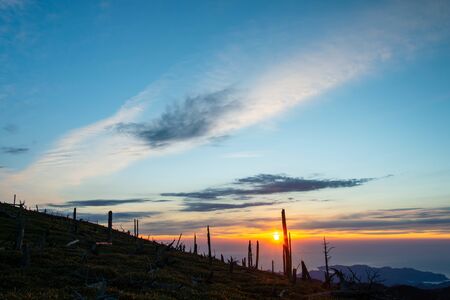 Mountain Slope, Morning Sun and Cloudsの写真素材