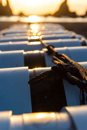 Lots of buoys and an orange sunrise.