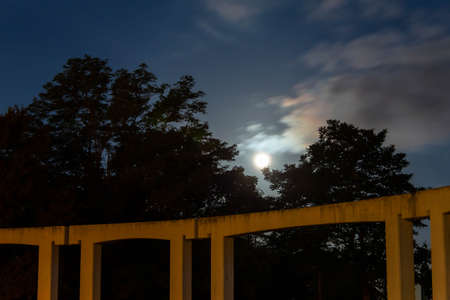 Full moonlight and concrete buildingsの写真素材
