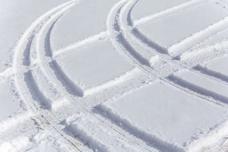 Tire tracks superimposed on fresh snowの写真素材