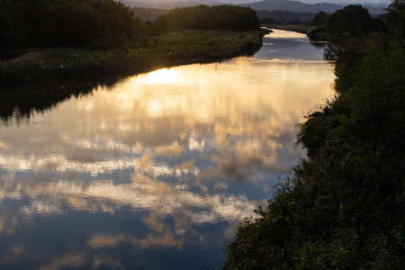 Morning glow reflected in a mountainous river