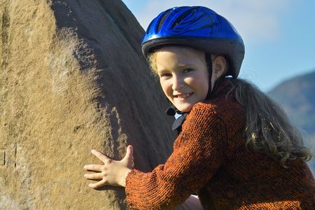 little girl climbing on the rockの写真素材