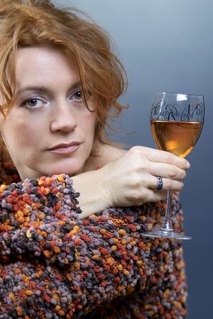 beautiful red hair sexy lady with glass of red wine in her handの写真素材