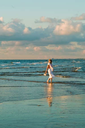 attractive blond girl at the seaside with seagullsの写真素材