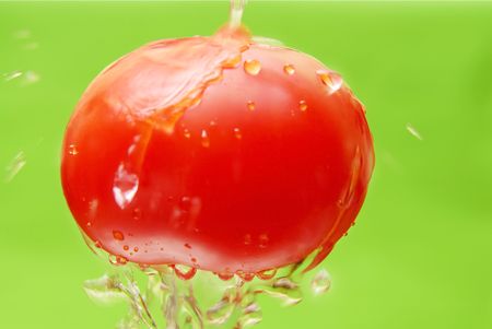 Fresh tomato under clear waterの写真素材
