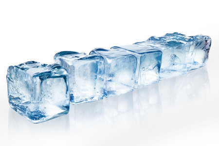 Ice cubes isolated in a row as a free plate in front of a white backgroundの素材