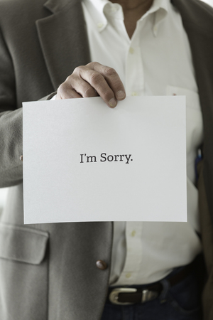 Man Holding I'm Sorry Signの写真素材