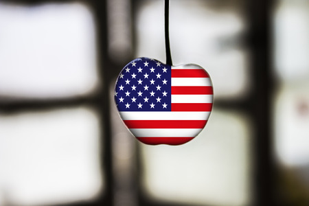 flag of USA painted on cherry or apple fruitの写真素材