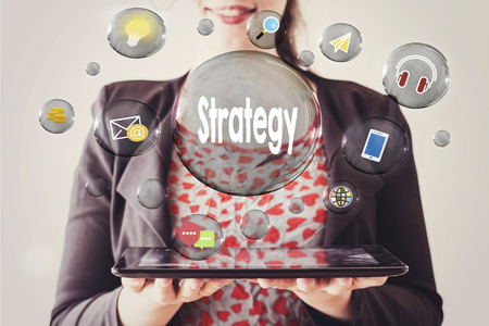 woman with beautiful smile holding a tablet and strategy concept in transparent bubbleの写真素材