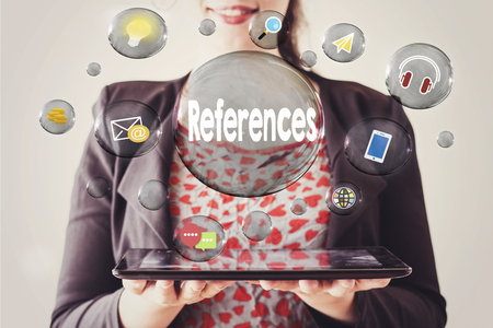 woman with beautiful smile holding a tablet and references concept in transparent bubbleの写真素材