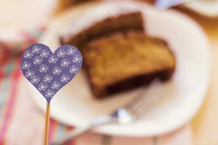 blue heart people on wood stick on cake blur backgroundの写真素材