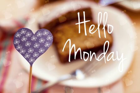 blue heart people on wood stick on cake blur background  with hello monday messageの写真素材