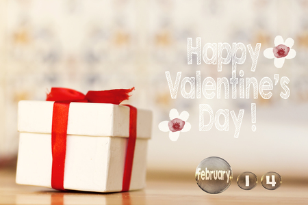 happy valentine's Day message with white gift box with red ribbon on wood background and transparent march bubblesの写真素材