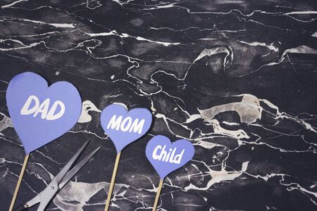 concept of divorce with three heart paper on wood stick,dad and mom and child