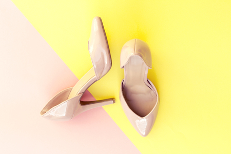 beautiful pink high heels on yellow and pink backgroundの写真素材
