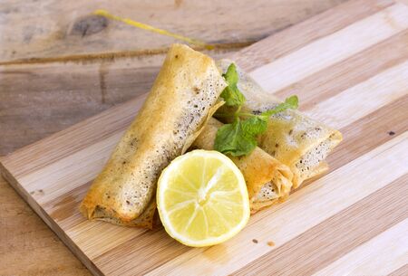 Turkish Pacanga Boregi with meat and cheddar decorated with slice lemon and leaves mint