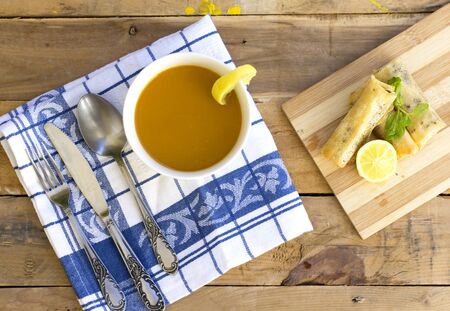 arabic soup in white bowl, and Turkish Pacanga Boregi  and cheddar decorated with slice lemon and...