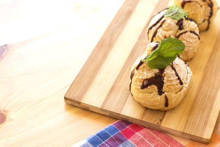 delicious homemade arabic eclairs on wood cutting boardの写真素材