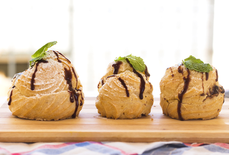 Delicious homemade Arabic eclairs on wood cutting board