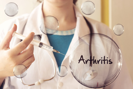 doctor woman holding a syringe and inject a arthritis bubbleの写真素材