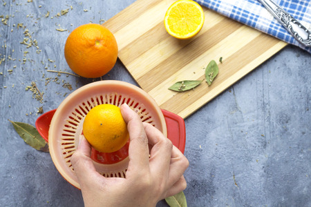 Closeup of woman making fresh  orange juiceの写真素材