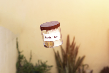 flying plastic pot saving algeria money for bank loan,levitation concept of moneyの写真素材