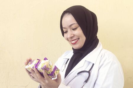 happy doctor muslim woman receive a gift box for holidayの写真素材
