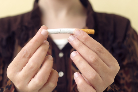 woman holding cigarette,concept  stop smoking paperの写真素材