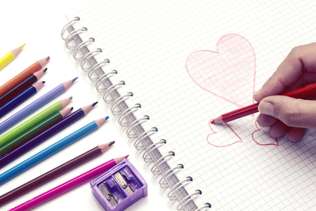 heart hand drawing on notebook and pencil for valentine's dayの写真素材