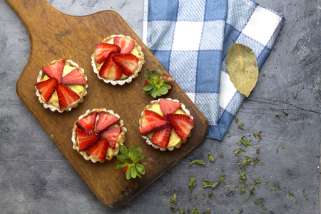delicious homemade arabic strawberry tartlet on cutting boardの写真素材