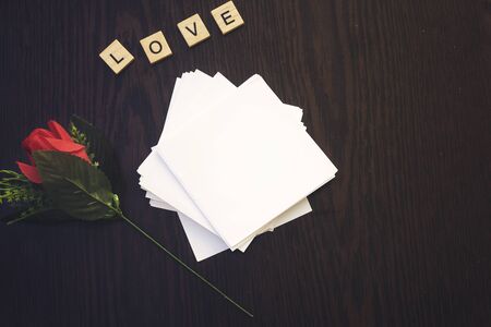 red rose flower and empty copy space paper with love wooden letters,Concept Valentines Day