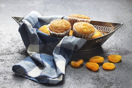 homemade arabic sugar muffins on boat shape silver plate with dry apricotの写真素材