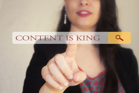 woman with beautiful smile and a braid hair and browsing content is king and point her finger to the search barsの写真素材