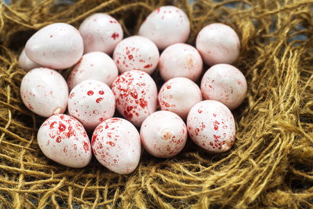 delicious pink chocolate easter eggs on nest, happy easter eggs conceptの写真素材
