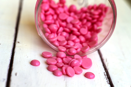 depilatory pearly pink  solid wax beans  on wood backgroundの写真素材