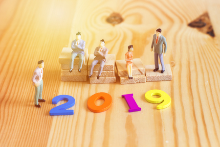 business mens with colorful wooden numbers forming the number 2019, For the new year 2019