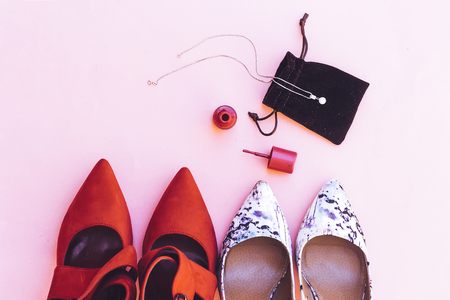 beautiful white and red pump hight heeled and pink nail polish bottle and white pearl necklaceの写真素材